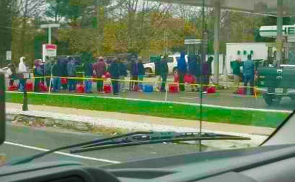 People Standing in Line for Gas