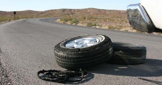 A flat Tire on the side of the Road